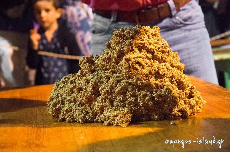 Amorgos, Chora, The Pasteli Festival - Gastronomy Tours close-up of ‘pasteli’ composition on the table at the Pasteli Festival, Amorgos, Chora, Greece surrounded by people by night